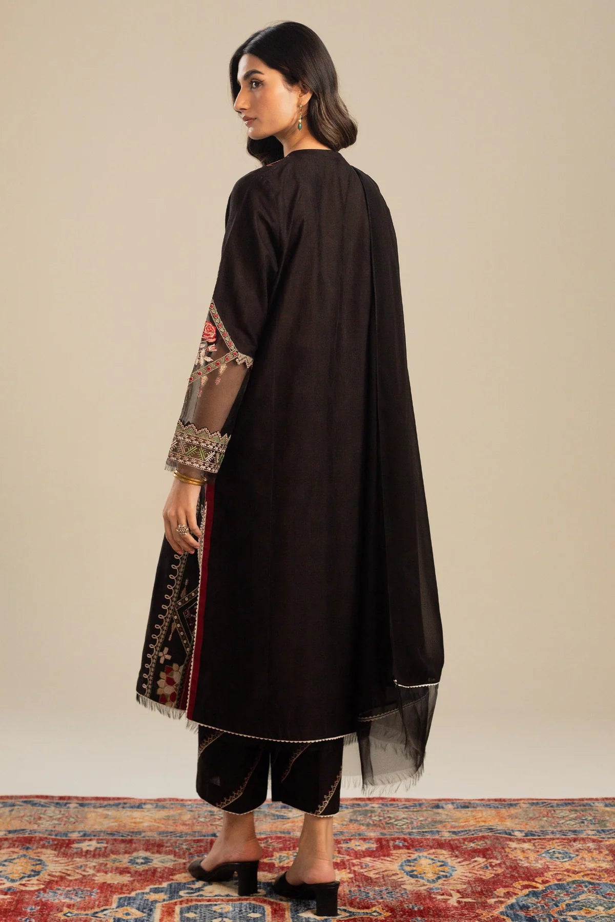 This long black kameez displays a beautiful fusion between traditional and modern cross-stitch embroidery By Zara Shahjahan